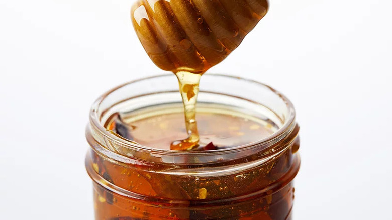 Spicy Calabrian Chile Honey in glass jar on white background