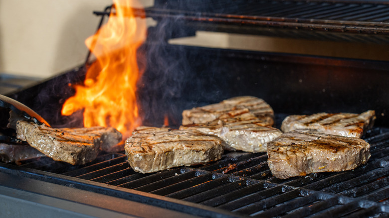 Tuna steaks cooking on outdoor grill