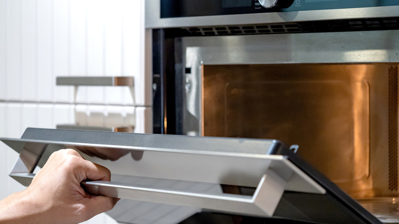 Hand opening oven door