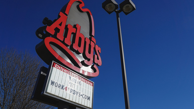 Arby's cowboy hat sign in front of blue sky