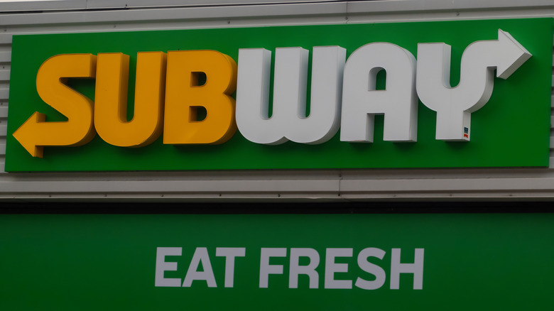 A Subway sign with Eat Fresh written underneath