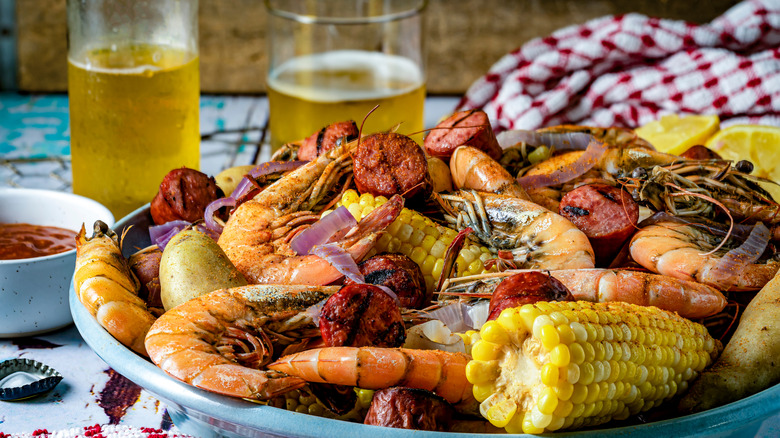 Traditional Frogmore Stew with corn and crayfish withglasses of beer