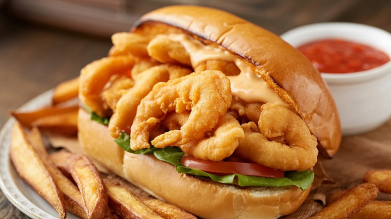 Shrimp po-boy on plate with fries