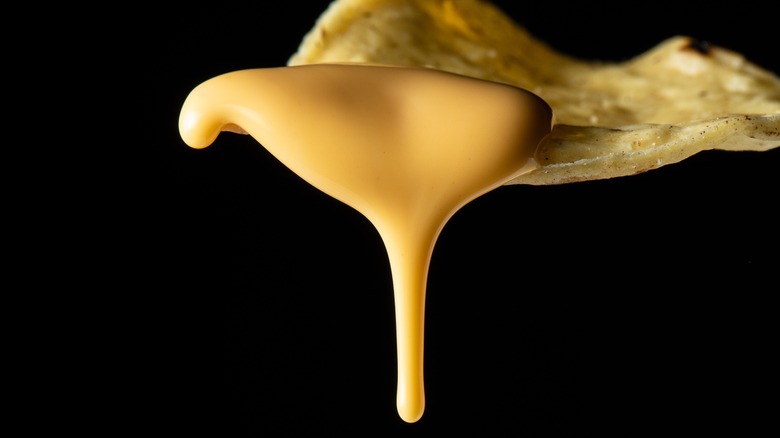 A chip with melting nacho cheese