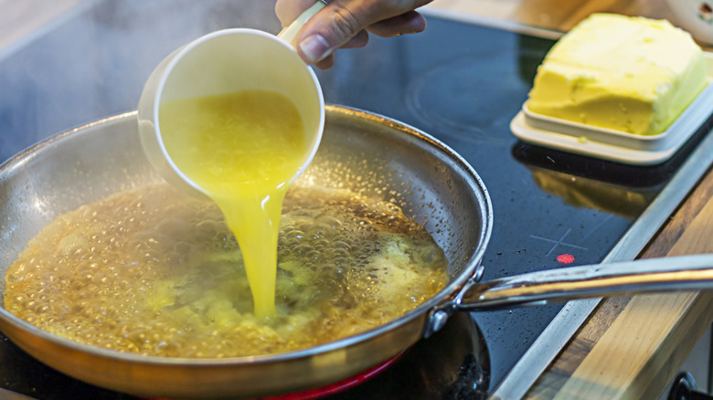 Orange juice is added to a bubbling pan