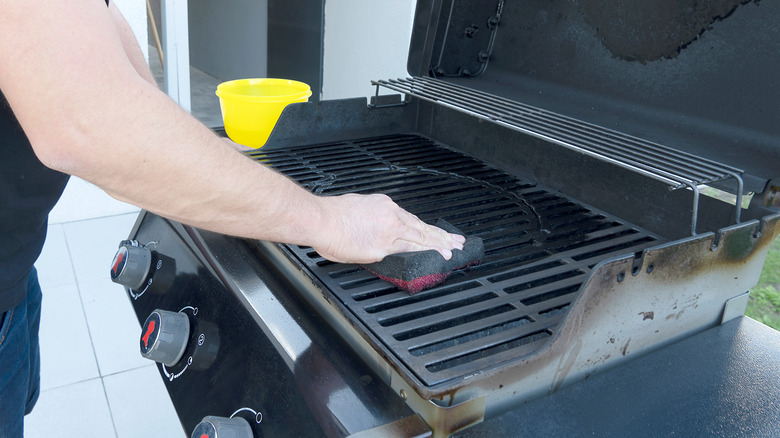 Hand cleaning a grill
