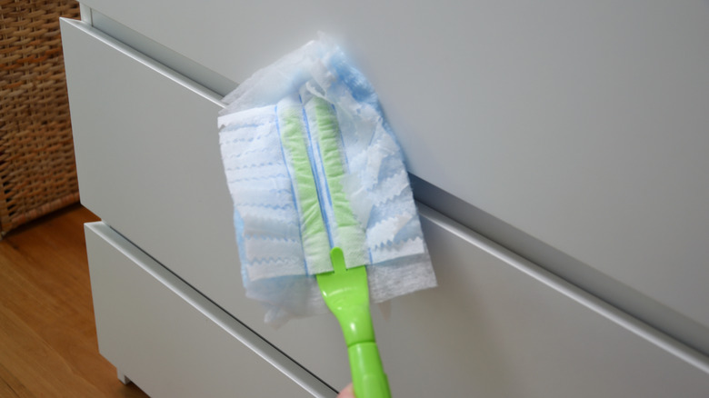 A Swiffer duster cleans drawers