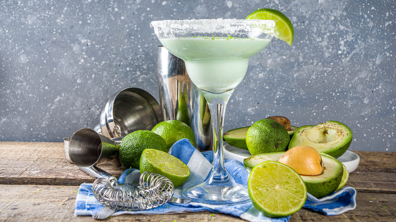 margarita displayed with lime and avocados