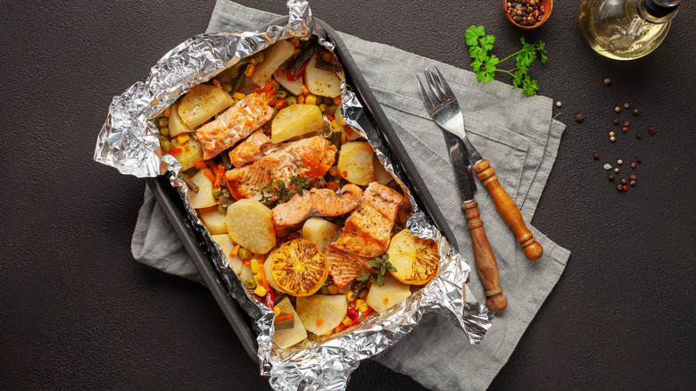 salmon and veggies in foil-lined pan