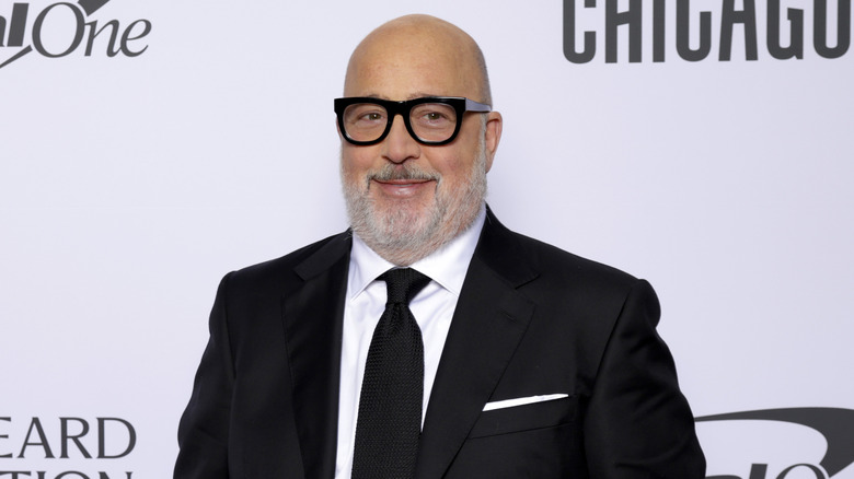 Andrew Zimmern in a suit at a carpet event