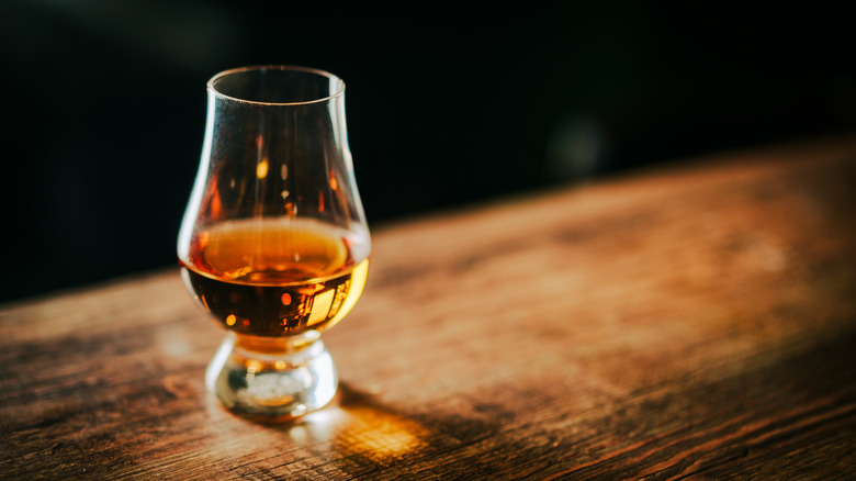 Glencairn glass of bourbon on bar