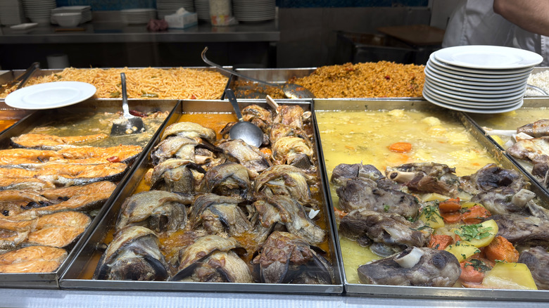 Buffet Line featuring fish, meat, rice, and noodle dishes