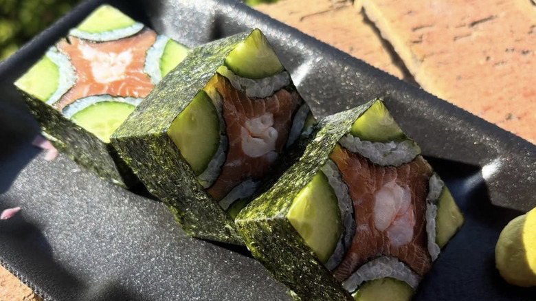 Mosaic sushi rolls with cucumber and salmon on plate