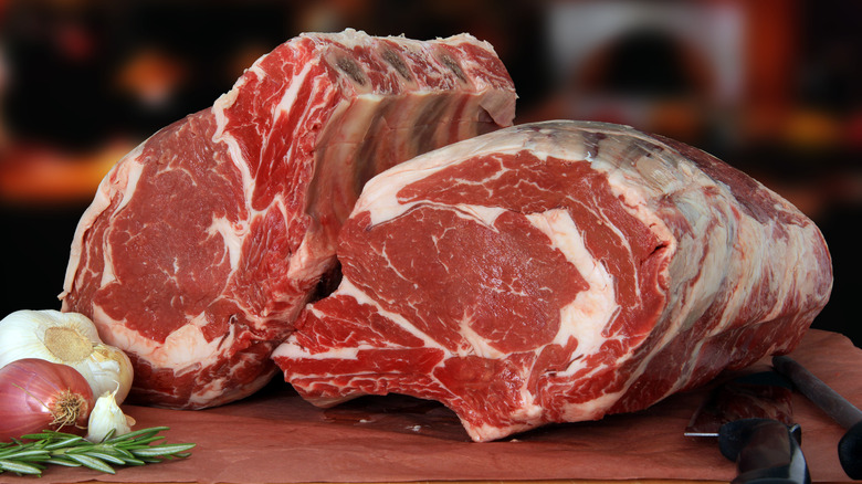 Two pieces of raw rib roast showing consistent white marbling throughout the meat.