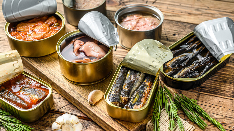 different canned seafood with open lids