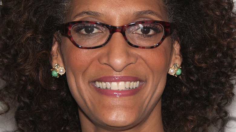 Carla Hall with glasses and green earrings