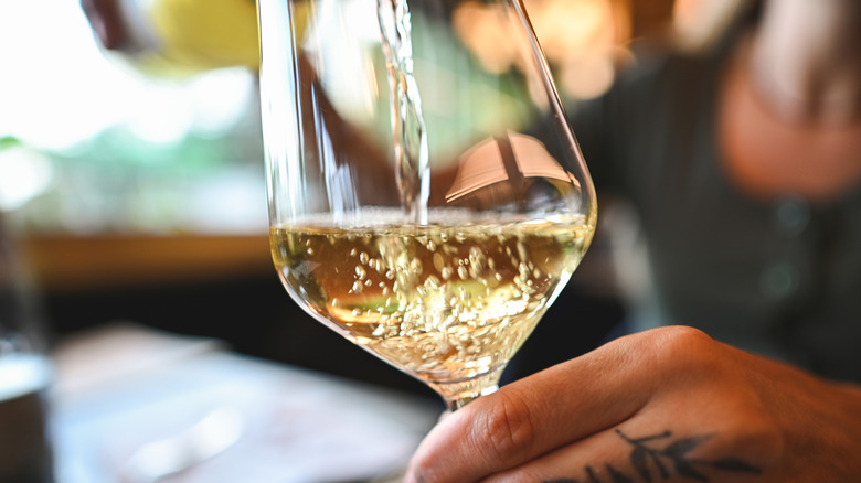White wine being poured into wine glass