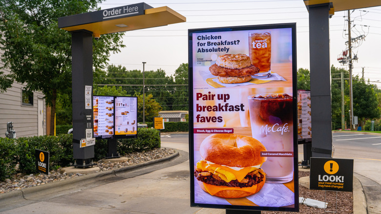 A screen with a digital breakfast menu in McDonald's drive-thru lane