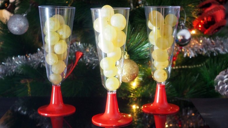champagne flutes holding 12 grapes