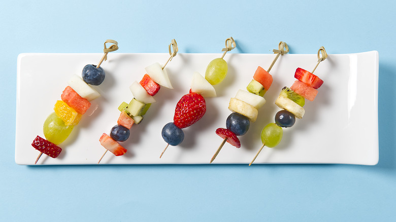 Fruit on skewers on a plate