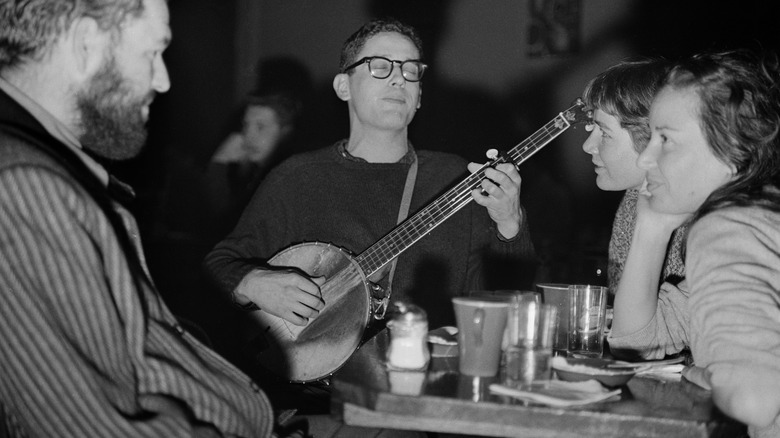 black and white man with banjo at coffee shop