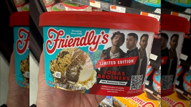A hand holding a carton of Friendly's Jonas Brothers ice cream
