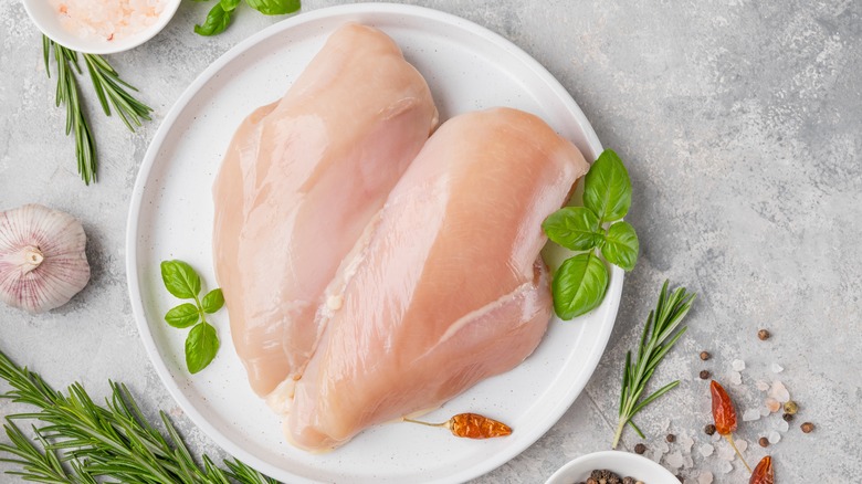Raw chicken with herbs and seasonings