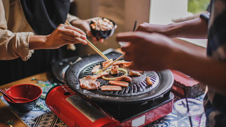People making Korean barbecue at home