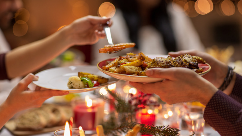 People sharing food at a dinner party