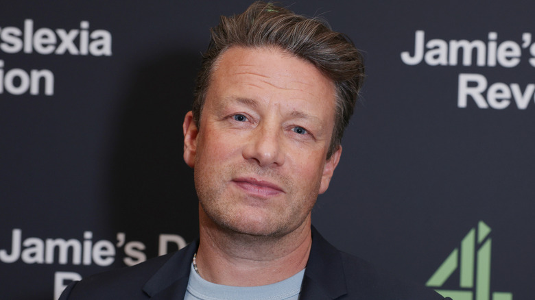 Closeup view of Jamie Oliver posing for a photo