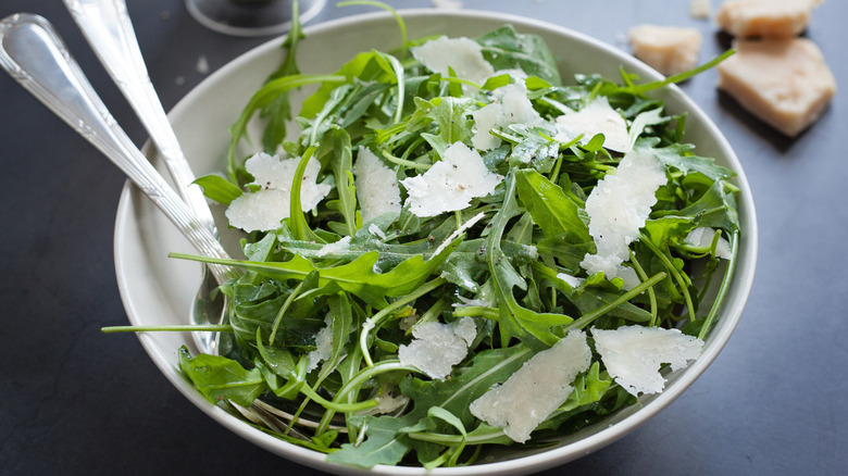 An arugula salad with shaved parmesan