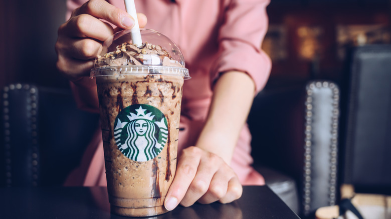 Hands holding a Starbucks Frappuccino 