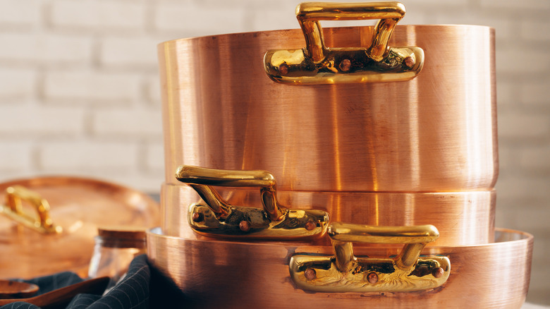 stacked copper pots and pans
