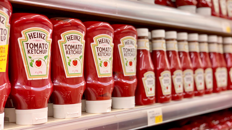 Bottles of Heinz tomato ketchup on store shelves