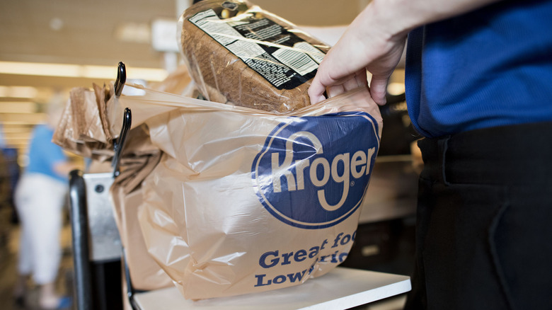 Kroger employee bagging groceries