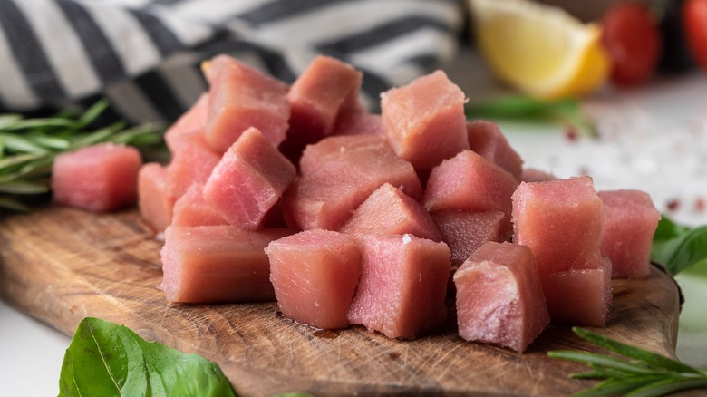 Cubed raw tuna on a cutting board