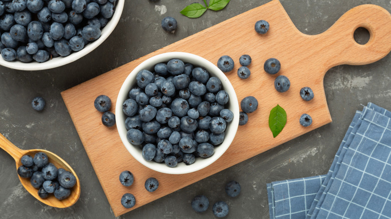 Blueberries in a bowl and on a chopping board