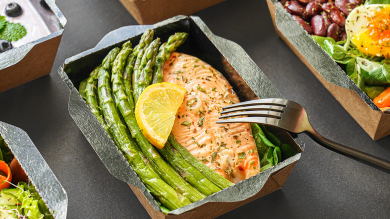 Cooked salmon in tray with vegetables