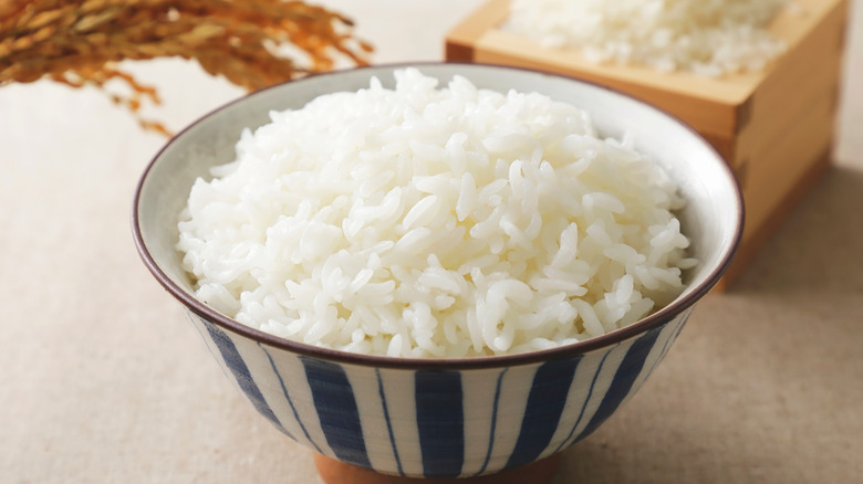 Fluffy rice in striped bowl