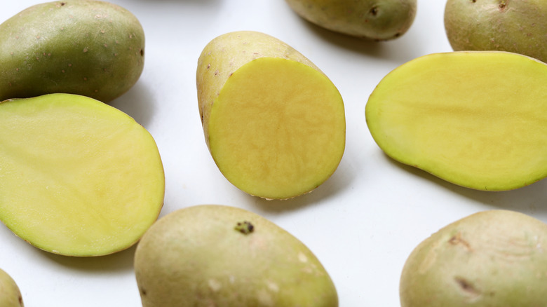 Raw potatoes cut open to show that they are green inside