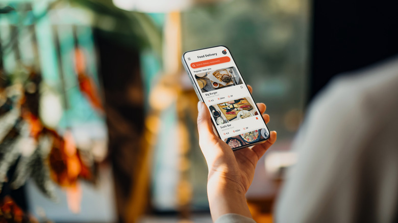 Foodie ordering takeout on a smartphone
