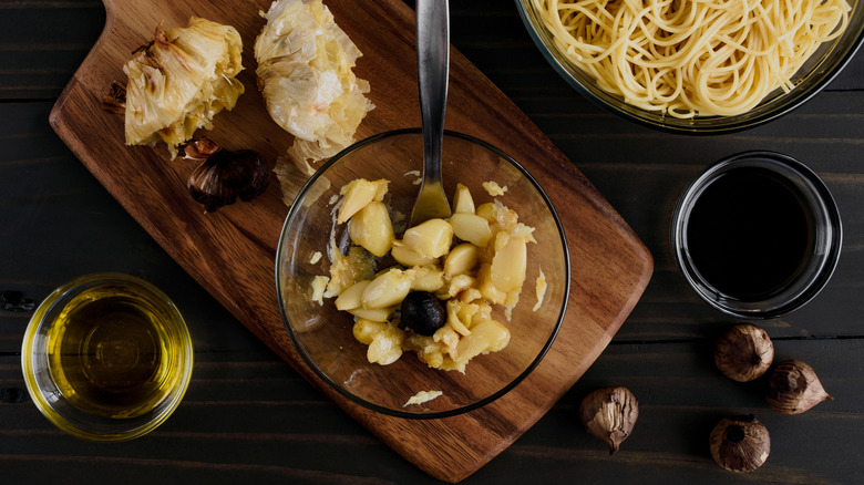Roasted garlic cloves mashed in a bowl