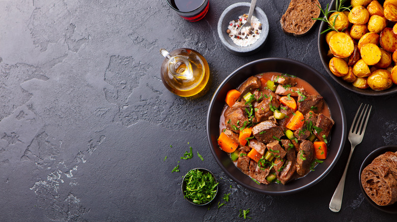 Bowl of beef stew with herbs.