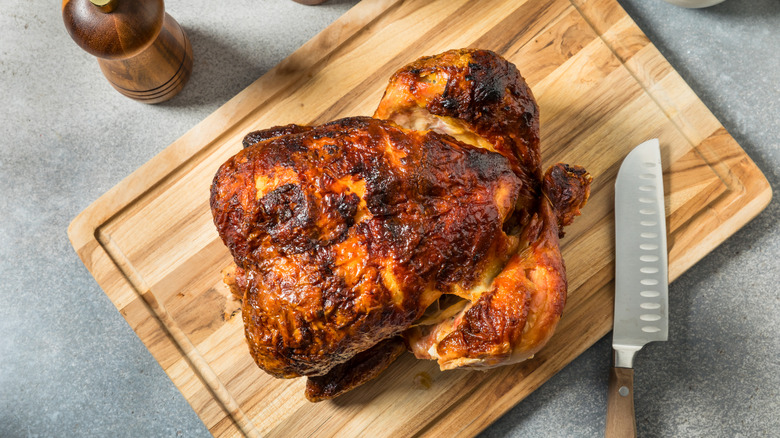Rotisserie chicken on cutting board