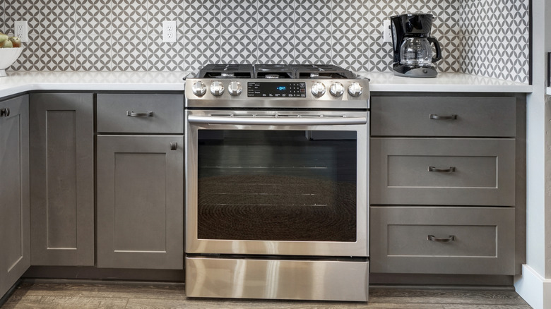 stainless steel oven in an all-gray kitchen