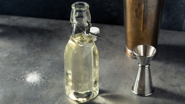 Simple syrup in bottle with jigger