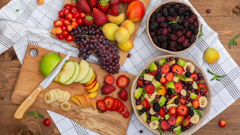 Fruit salad and fruits on wooden boards