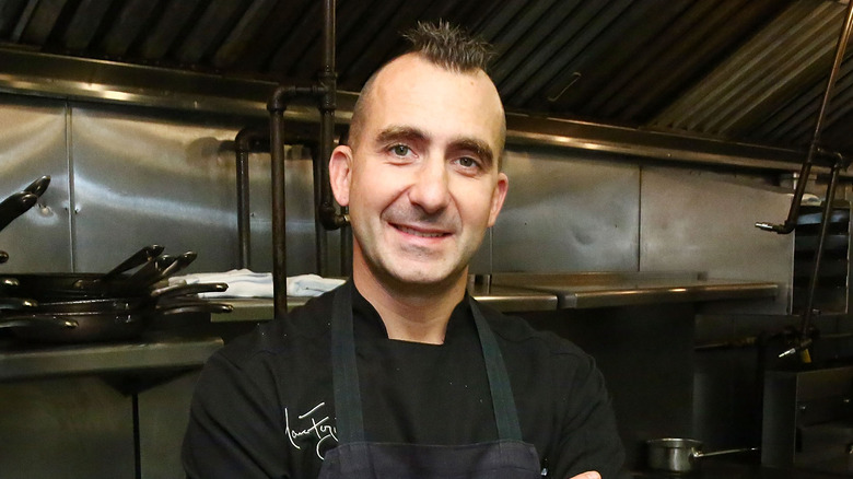 Marc Forgione standing in front of kitchen