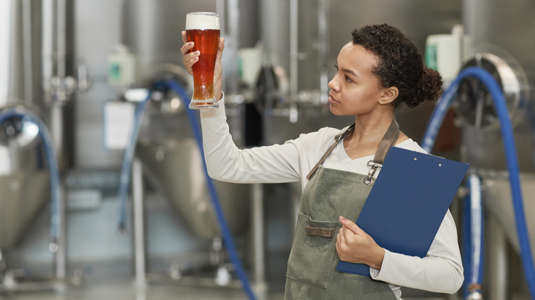woman in brewery holding beer