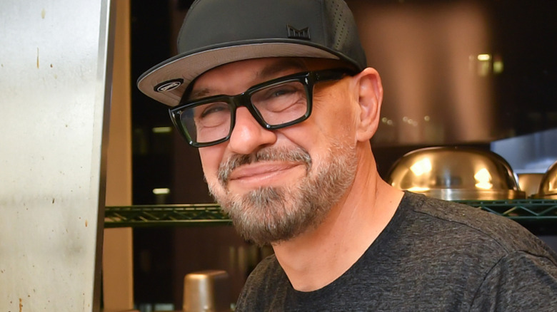 Chef Michael Symon in restaurant kitchen with cap on